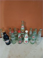 Set of glass soda bottles, including coca-cola,