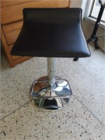 Height adjustable swivel bar stool with foot rest.