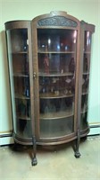 Antique curved glass cabinet / claw feet on