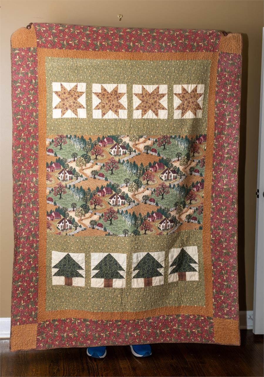Handmade quilt with a village theme