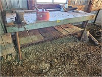 93" work table with vise, gas can, and metal