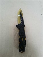 New pocket knife with gold and black colored