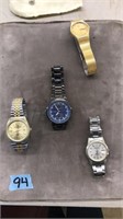 Four assorted men’s wrist watches