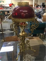 Brass Victorian lamp with a red glass shade,