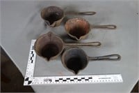 Four (4) cast iron ladles