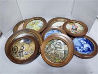 10 collectable plates in wood frames