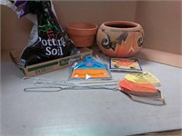 Clay pots, partial bag potting soil, fly