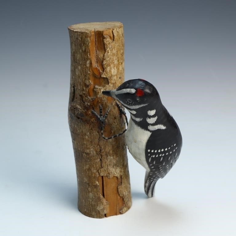 Woodpecker bird carving on a log