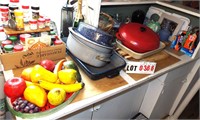 bottom shelf: roasting pans, LeCreuset,