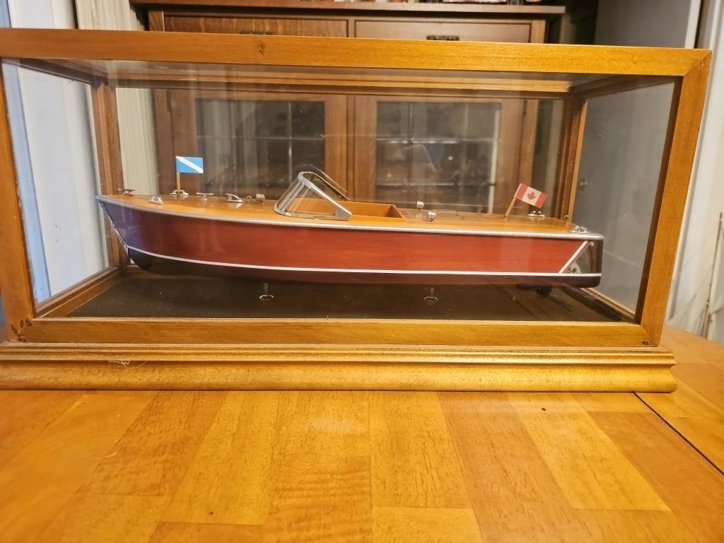 Chris Craft vintage wooden boat in glass case.