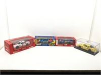 4 die cast model cars in boxes.