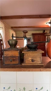 Two antique wood and iron coffee grinders, one