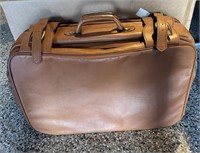 Brown vinyl suitcase with handle