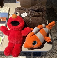 Tickle me Elmo, stuffed Nemo and brown blanket