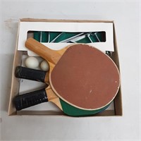 Assorted ping pong paddles and a few balls