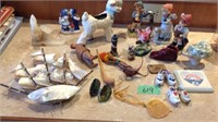 Assorted figurines, shell sail boat