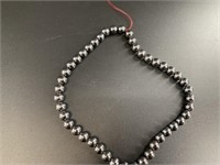 String of 1/4in hematite beads 16in long, no clasp