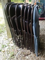 Nine metal folding chairs