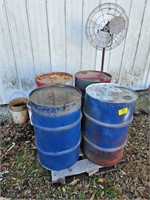 pallet of metal barrels, waste oil, metal fan