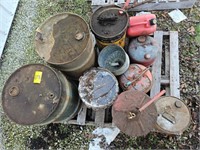 pallet with metal barrels, vintage gas cans,