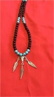 Skull and feathers charm necklace with beads
