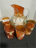 Carnival glass pitcher with 6 cups