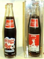 TWO COMMEMORATIVE COKE BOTTLES