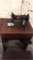 Domestic vintage sewing machine in cabinet