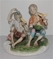 Figurine of boys eating melon & grapes, 8 1/2"