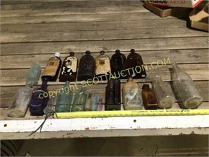 20 glass bottles, mostly made by a Warner