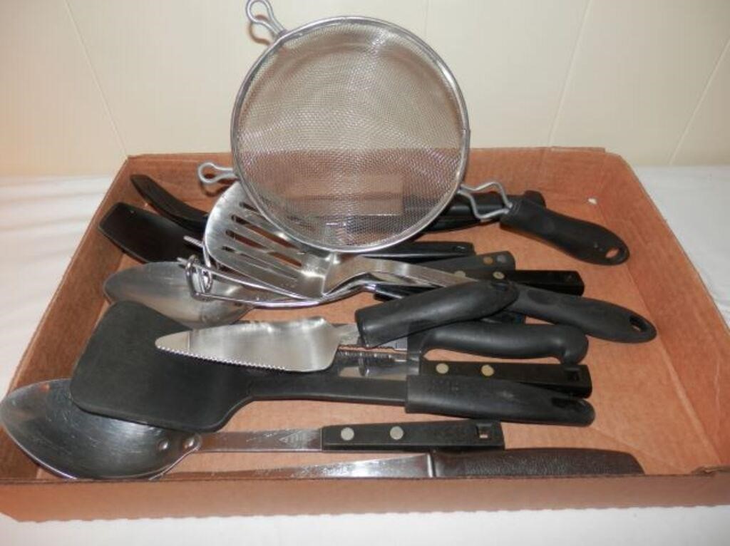 Tray of black handled kitchen utensils