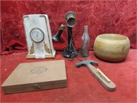 Old clock, candlestick telephone lamp, wood bowl.