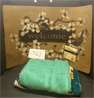 Mixed towel lot and welcome mat