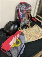 Helmet, Jurassic Park backpack, and three
