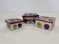 Set of three small nesting tin boxes