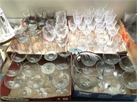 4 flats of stemware and etched pitcher