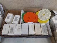assortment of sanding and buffing pads