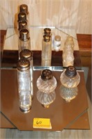 7 SETS OF SALT AND PEPPERS AND GLASS DRESSER
