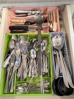 Drawer full of assorted stainless flatware