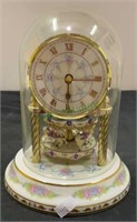 Carousel clock with porcelain base glass globe