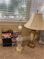 Pair of lamps and VHS movies with some DVDs.