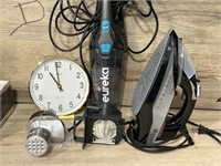 5 items total. Venmi iron, eureka vacuum, clock,