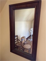 Walnut framed wall mirror measures 47 inches tall