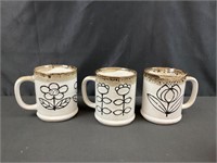 Three MCM coffee cups
