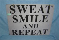 Sweat smile and repeat style advertising sign