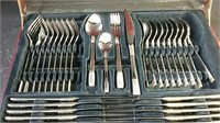 Set of silverware and serving utensils in case