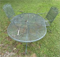 Green metal table and two chairs matching