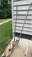 Antique wood handle iron wheel garden plow, with