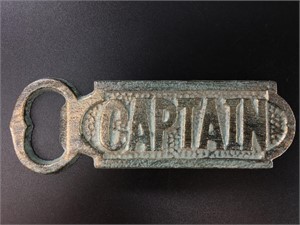 Cast iron bottle opener with faux patina says "Cap