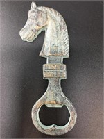 Cast iron horse head bottle opener with a faux gre